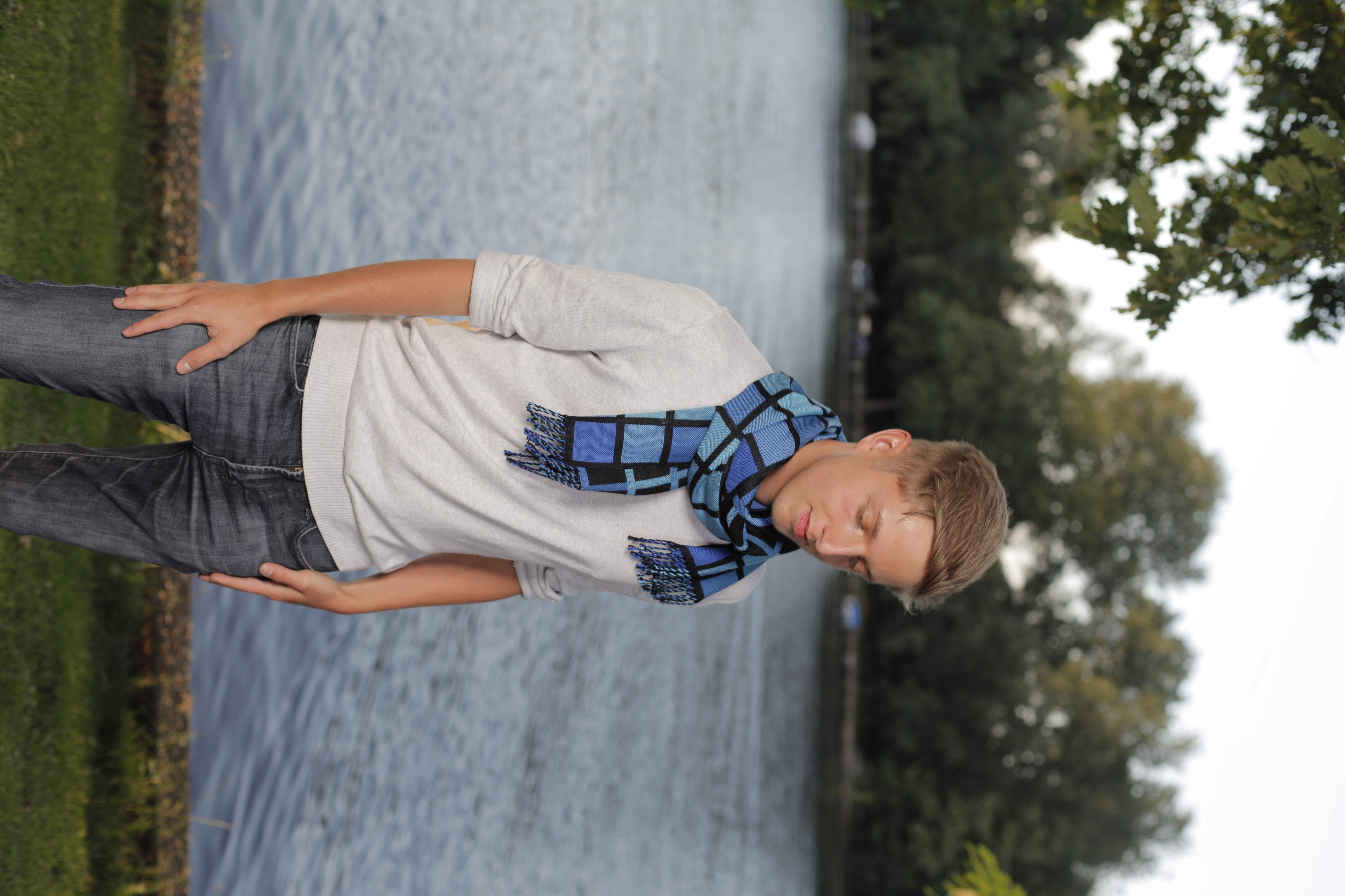 A blue and black patterned Lífve Fashion scarf worn outdoors beside the water.