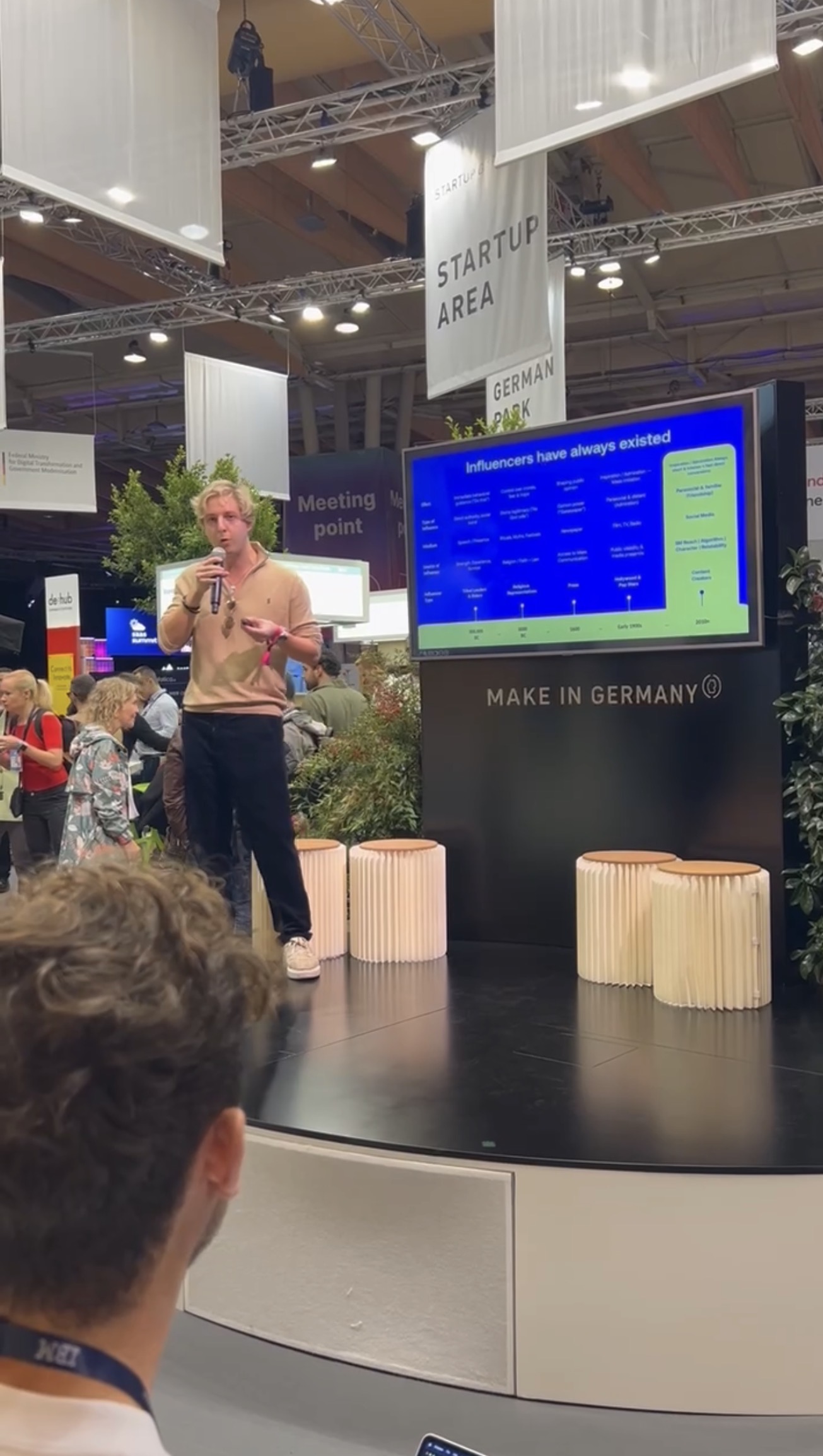Sören speaking beside his slides in the Make in Germany area at Web Summit Lisbon